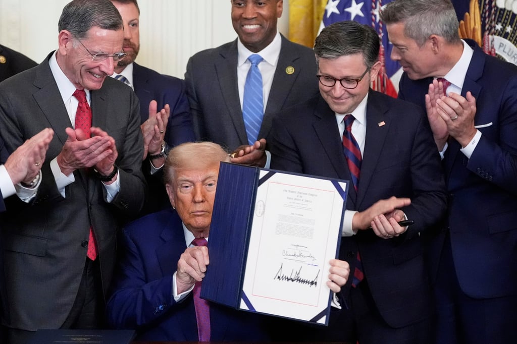 President Donald Trump holds up a signed bill blocking California’s rule banning the sale of new petrol-powered cars by 2035. Photo: AP