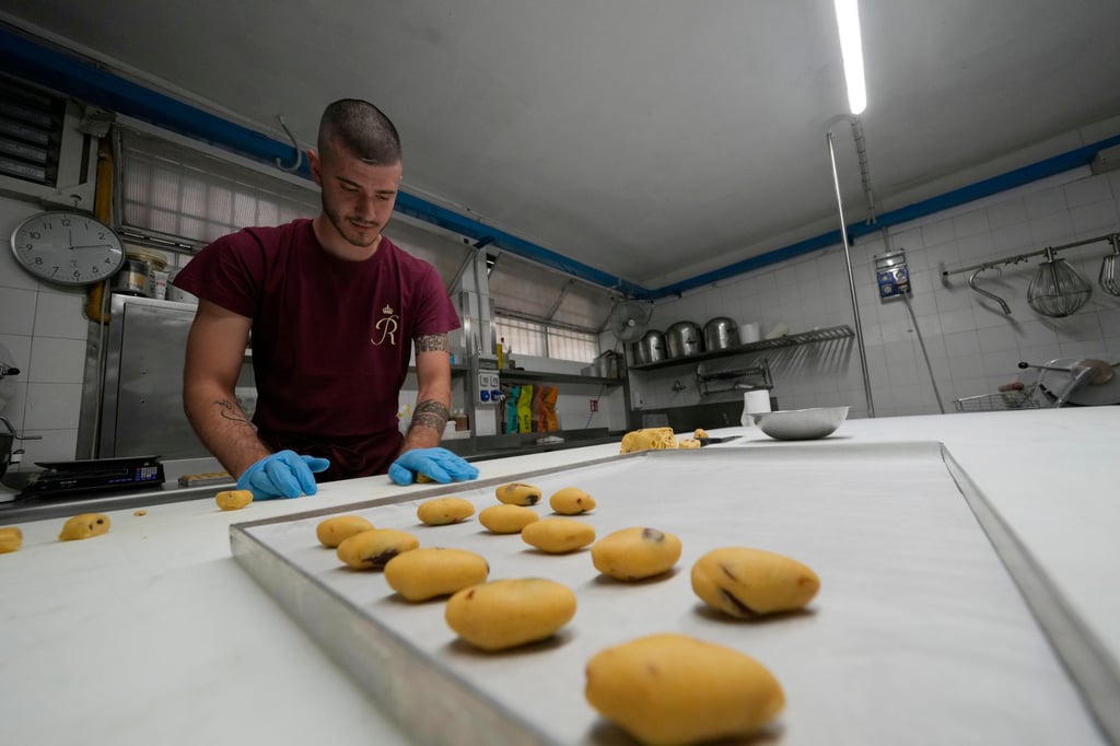 Pastry chef Elias prepares traditional Zaletti biscuits at the Rosa Salva pastry kitchen in Venice. Photo: AP