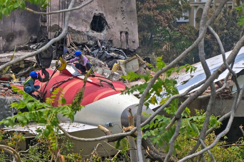 Workers remove wreckage from the Air India crash in a residential area near the airport in Ahmedabad on Saturday. Photo: AFP