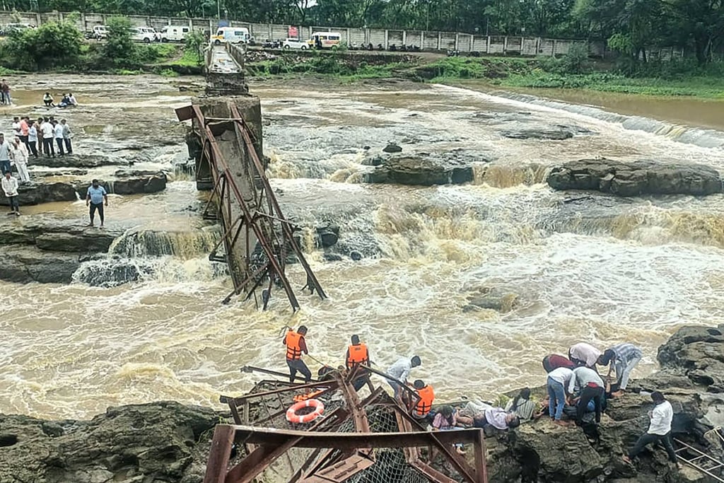 Rescuers work at the site of the collapsed bridge over the Indrayani River on Sunday. Photo: AFP