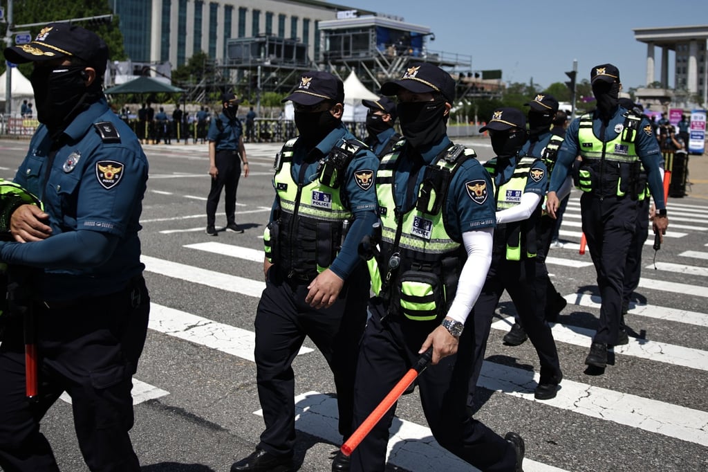 South Korean police officers cross a road in Seoul earlier this month. Photo: EPA-EFE South Korean police officers cross a road in Seoul earlier this month. Photo: EPA-EFE