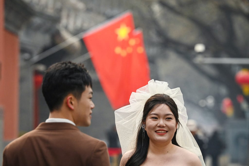 A couple poses for wedding photos in Beijing. Photo: AFP