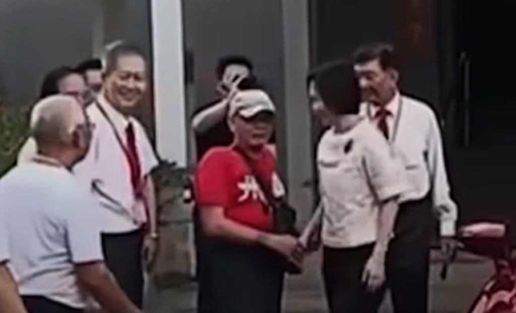 A video capture shows Minister of State Gan Siow Huang (second from right) shaking the hand of Leong Chee Leng of Kwong Wai Siew Peck San Theng, a Cantonese cultural organisation in Singapore. Photo: Handout A video capture shows Minister of State Gan Siow Huang (second from right) shaking the hand of Leong Chee Leng of Kwong Wai Siew Peck San Theng, a Cantonese cultural organisation in Singapore. Photo: Handout