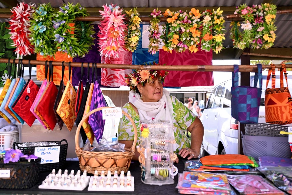 A stallholder displays her wares to tourists at a market on Rarotonga in the Pacific nation of the Cook Islands earlier this month. Photo: AFP A stallholder displays her wares to tourists at a market on Rarotonga in the Pacific nation of the Cook Islands earlier this month. Photo: AFP