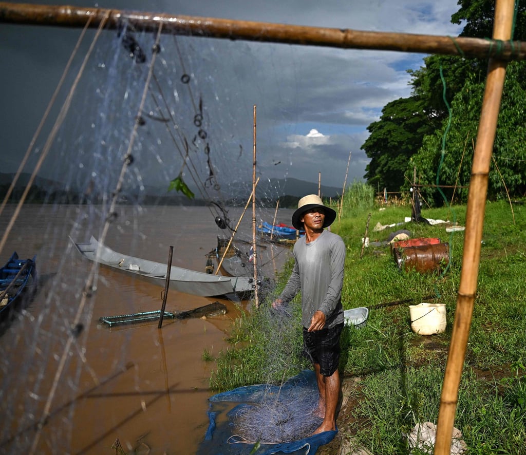 Thai fisherman Sawat Kaewdam sorts his fishing net along the banks of the Mekong River in the Golden Triangle region in northern Thailand’s Chiang Rai province. Photo: AFP Thai fisherman Sawat Kaewdam sorts his fishing net along the banks of the Mekong River in the Golden Triangle region in northern Thailand’s Chiang Rai province. Photo: AFP
