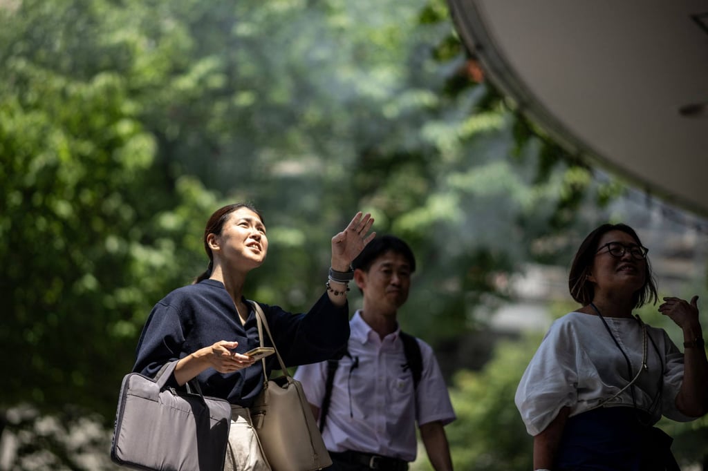 People walk down a street in the Yurakucho district in Tokyo, where temperatures topped 34 degrees Celsius on Wednesday. Photo: AFP People walk down a street in the Yurakucho district in Tokyo, where temperatures topped 34 degrees Celsius on Wednesday. Photo: AFP