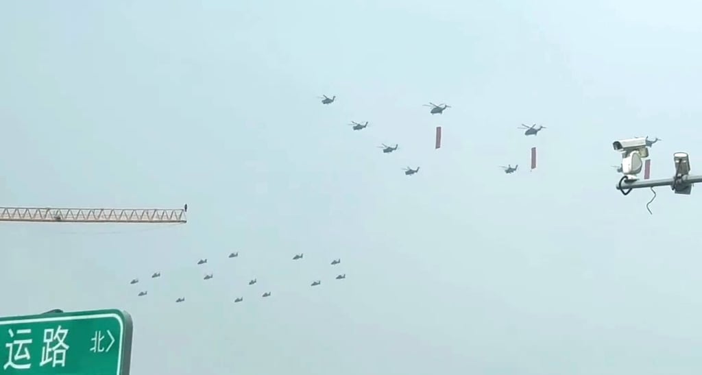 A clip posted to RedNote purportedly shows PLA helicopters flying in formation, some of them carrying red flags. Photo: Handout A clip posted to RedNote purportedly shows PLA helicopters flying in formation, some of them carrying red flags. Photo: Handout