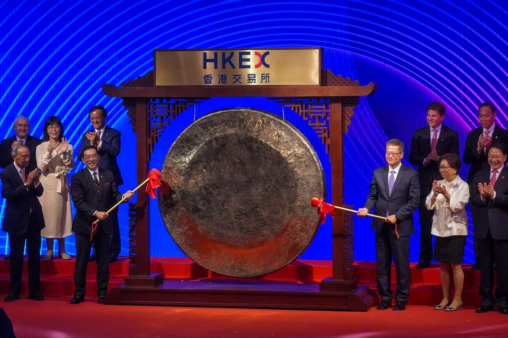 HKEX chairman Carlson Tong (left) and Financial Secretary Paul Chan strike a gong to officially launch the celebrations to mark the exchange’s 25th anniversary on Friday. Photo: Elson Li HKEX chairman Carlson Tong (left) and Financial Secretary Paul Chan strike a gong to officially launch the celebrations to mark the exchange’s 25th anniversary on Friday. Photo: Elson Li
