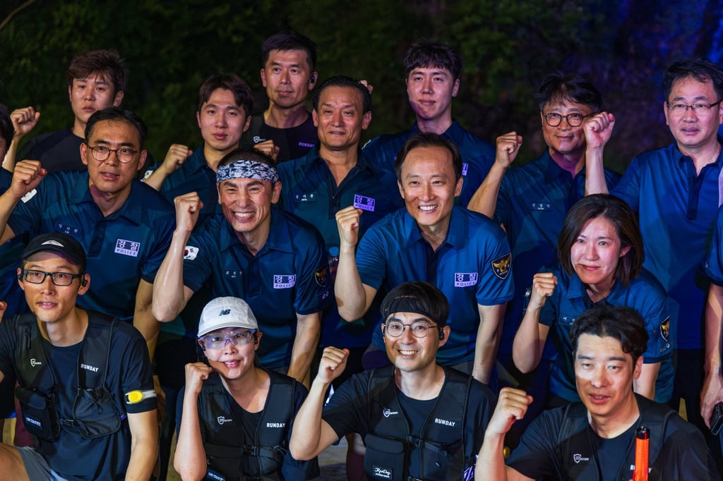 Members of the Be Ready Running Club pose for a photo with police officers after completing a task along a stream in northwestern Seoul, as part of the city’s Running Patrol programme. Photo: Kim Jung-yeop Members of the Be Ready Running Club pose for a photo with police officers after completing a task along a stream in northwestern Seoul, as part of the city’s Running Patrol programme. Photo: Kim Jung-yeop