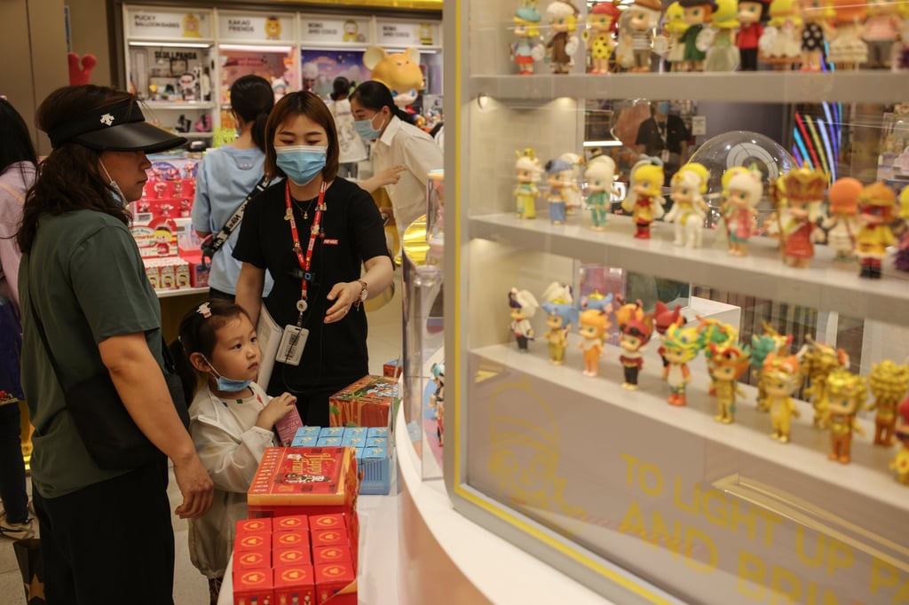A girl looked at “blind boxes” at a Pop Mart store in Beijing on June 3 2021. Photo: EPA-EFE A girl looked at “blind boxes” at a Pop Mart store in Beijing on June 3 2021. Photo: EPA-EFE