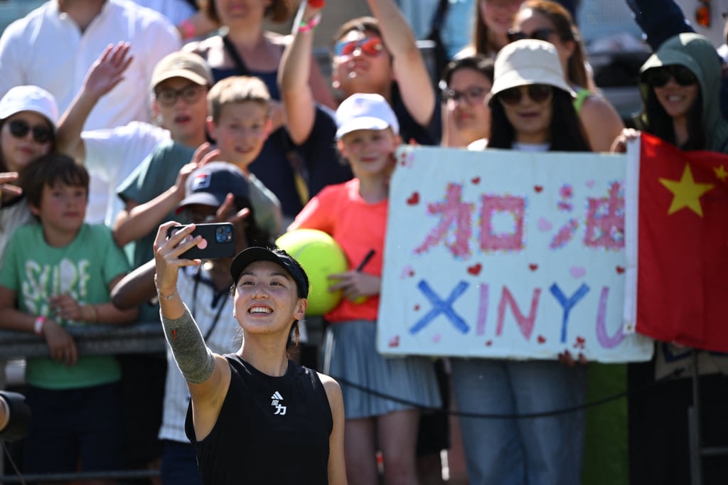 China’s Wang Xinyu takes a selfie with fans after her win. Photo: Reuters