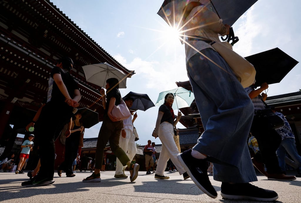Passers-by carry parasols to shade themselves from the heat in Tokyo, Japan, in July 2024. Prolonged heatwaves affected East Asia from April to November last year. Photo: Reuters Passers-by carry parasols to shade themselves from the heat in Tokyo, Japan, in July 2024. Prolonged heatwaves affected East Asia from April to November last year. Photo: Reuters
