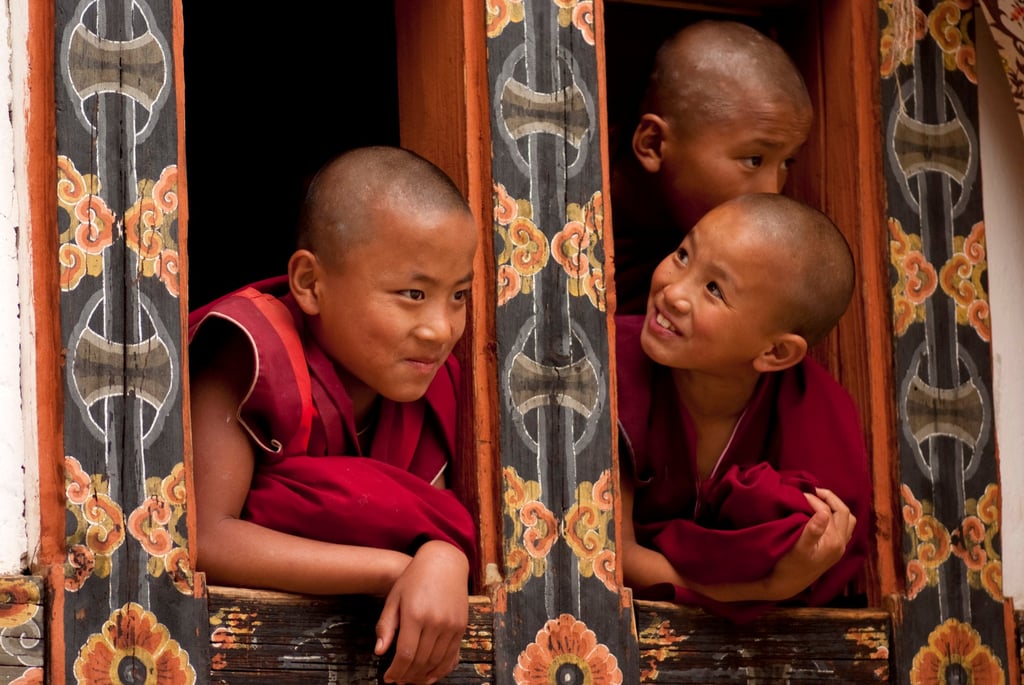 Three young Buddhist monks peer out from a monastery window in Bumthang Valley, Bhutan. Photo: Getty Images Three young Buddhist monks peer out from a monastery window in Bumthang Valley, Bhutan. Photo: Getty Images
