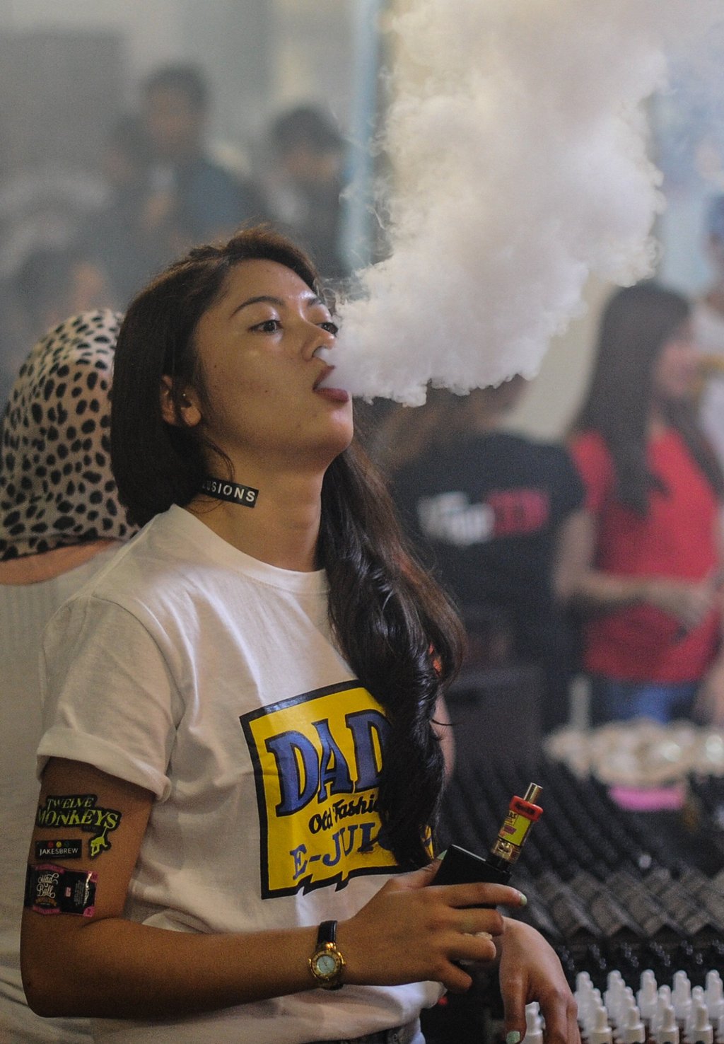 A promoter smokes an e-cigarette during the Vape Fair in Kuala Lumpur. Photo: AFP