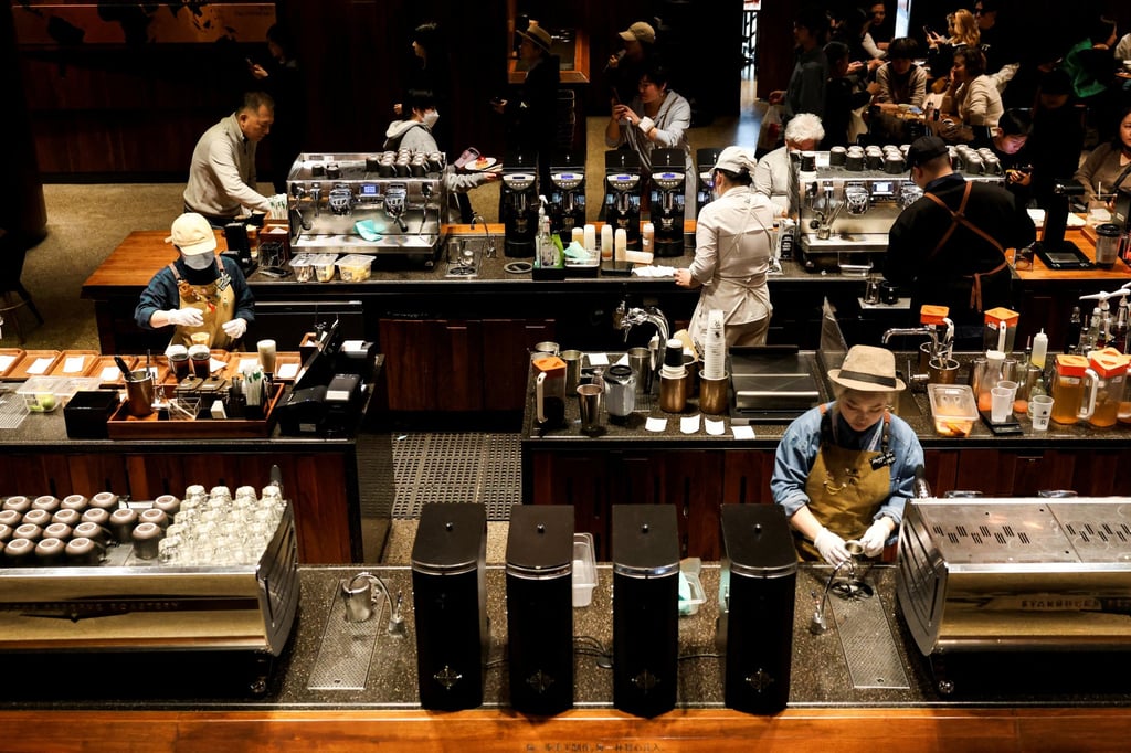 Baristas at work at a Starbucks Reserve Roastery in Shanghai. Photo: Reuters Baristas at work at a Starbucks Reserve Roastery in Shanghai. Photo: Reuters