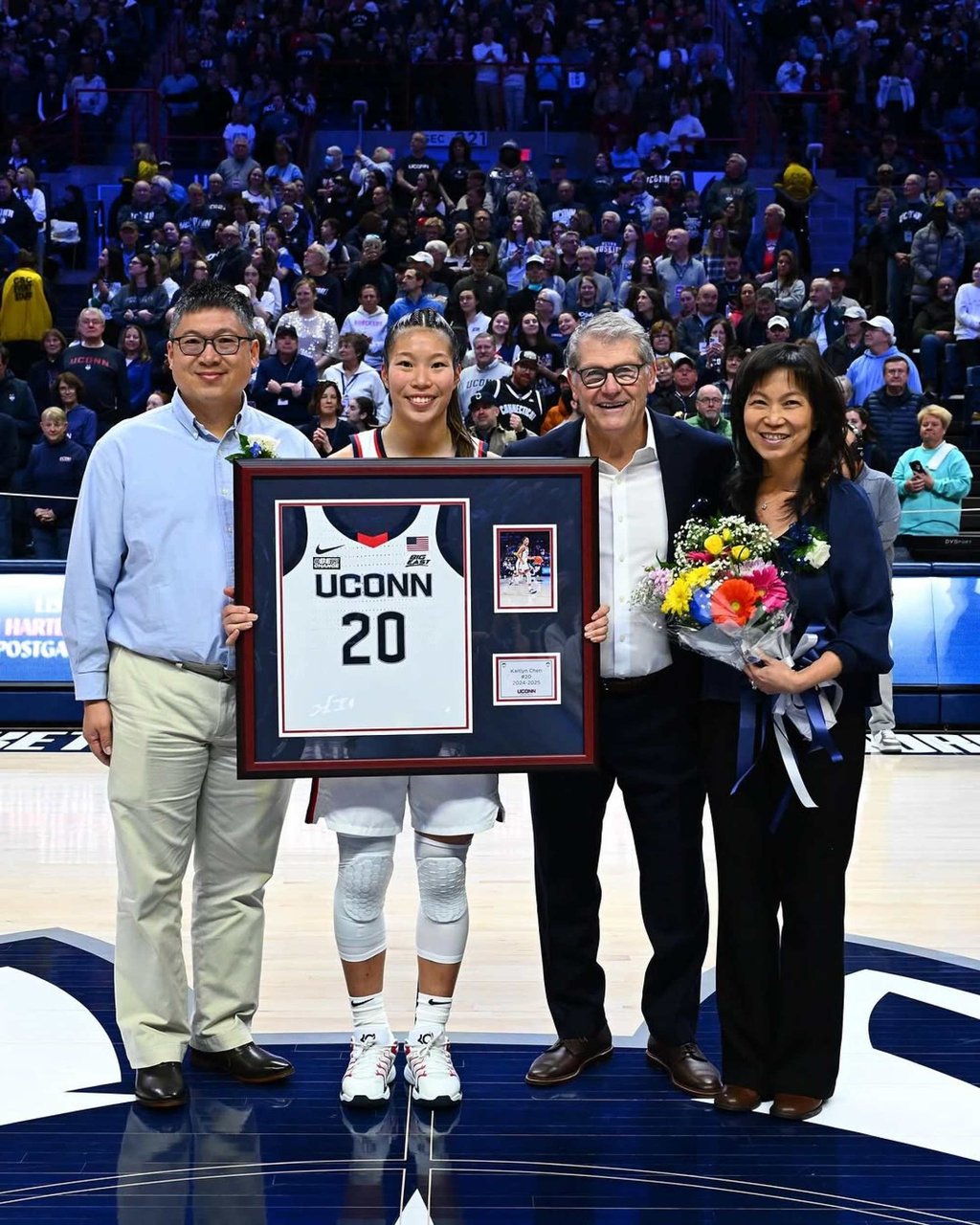 Kaitlyn Chen, flanked by her parents, holds up her UConn Huskies jersey during Senior Day celebrations after a NCAA women’s game. Photo: @kaitlyn.chen/Instagram