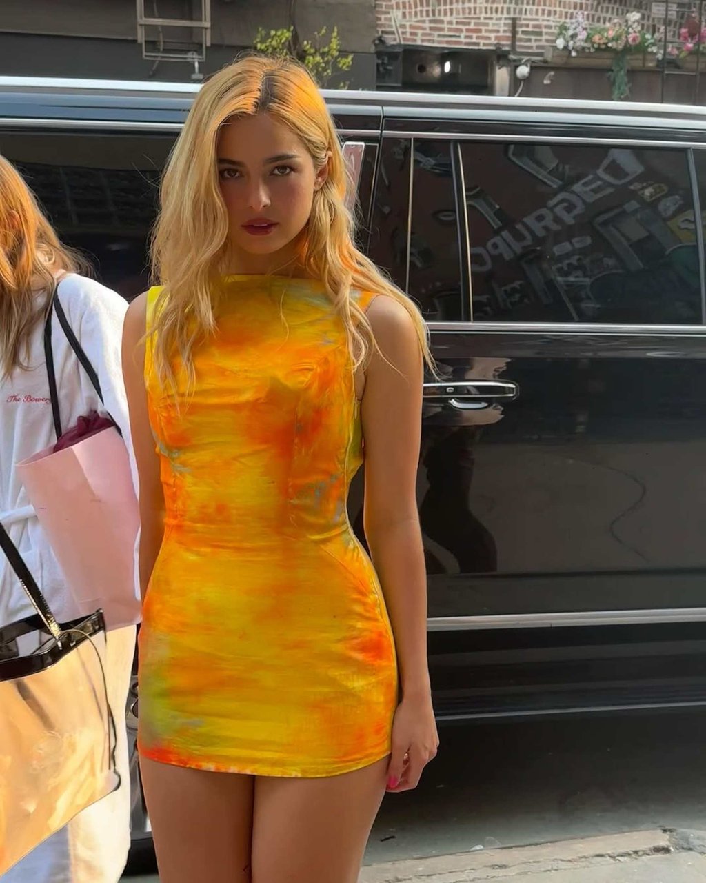 Addison Rae wears a tie-dyed orange and yellow dress designed by Dara Allen. Photo: @dara._/Instagram