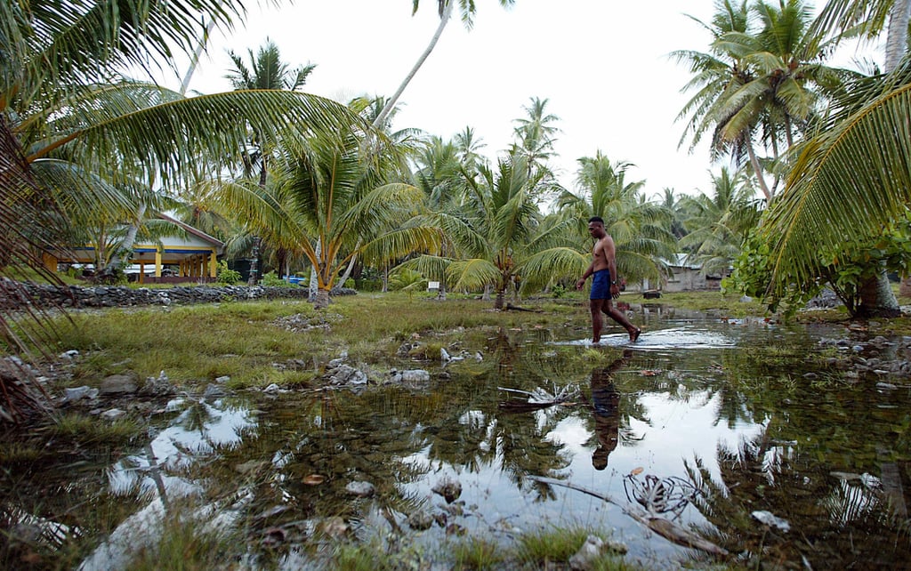 Water welling from the rocky ground forms a new lake in the centre of Amatuku Islet of Funafuti, Tuvalu. About 3,125 Tuvaluans have applied for a climate visa to live in Australia. Photo: AFP Water welling from the rocky ground forms a new lake in the centre of Amatuku Islet of Funafuti, Tuvalu. About 3,125 Tuvaluans have applied for a climate visa to live in Australia. Photo: AFP