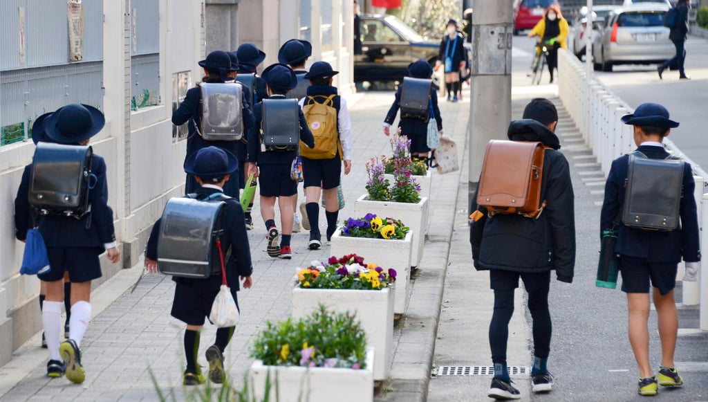 Primary school pupils head for classes in Osaka, western Japan. Photo: Kyodo/AP Primary school pupils head for classes in Osaka, western Japan. Photo: Kyodo/AP