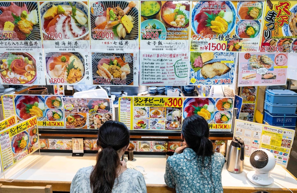 Two women wait for an early morning meal at one of the many small seafood restaurants at the Tsukiji fish market. Photo: AFP Two women wait for an early morning meal at one of the many small seafood restaurants at the Tsukiji fish market. Photo: AFP