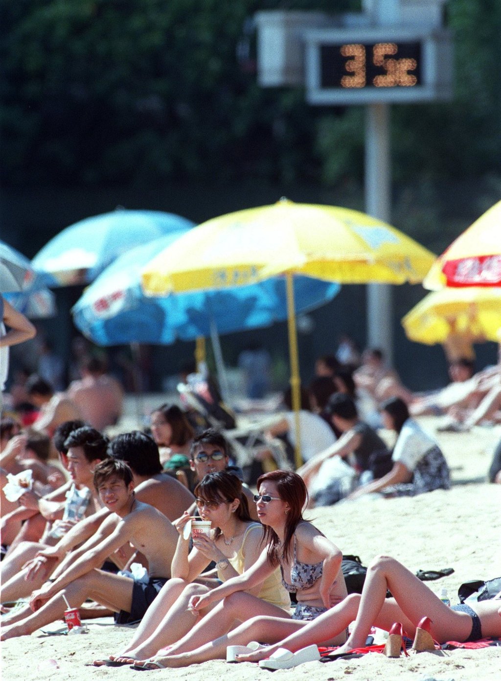 Soaking up the sun as temperatures in Hong Kong hit the mid-30s in May 2002. Photo: SCMP Archives Soaking up the sun as temperatures in Hong Kong hit the mid-30s in May 2002. Photo: SCMP Archives