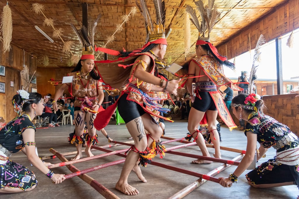 A native bamboo dancing performance during a harvest festival in Malaysia’s Sabah state. All three husbands have embraced the country’s culture. Photo: Shutterstock A native bamboo dancing performance during a harvest festival in Malaysia’s Sabah state. All three husbands have embraced the country’s culture. Photo: Shutterstock