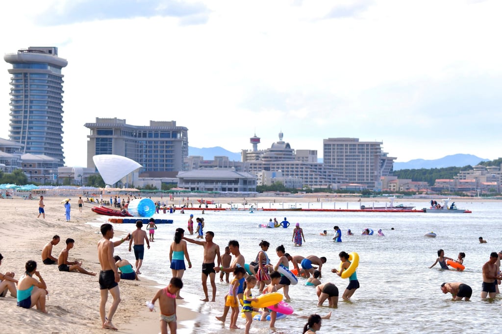North Koreans relax on the beach at the Wonsan-Kalma eastern coastal tourist zone on Tuesday. Photo: KCNA / KNS / AP