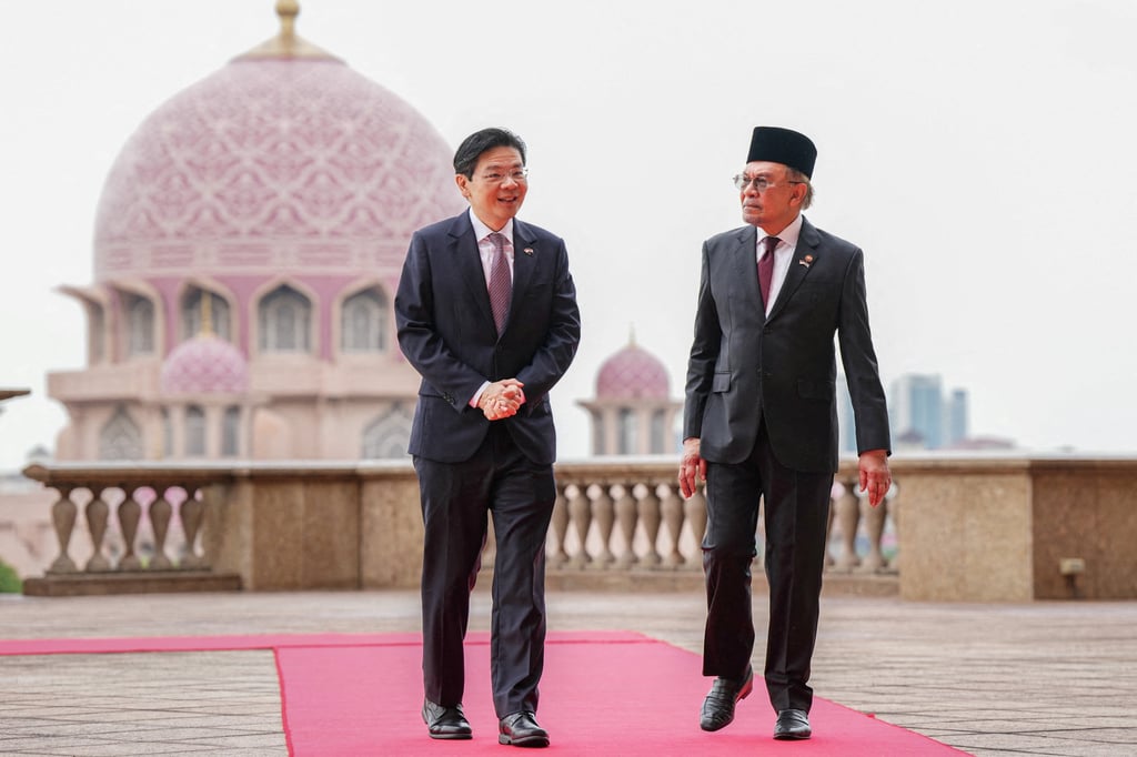 Singapore Prime Minister Lawrence Wong walks with Malaysian Prime Minister Anwar Ibrahim in Putrajaya, Malaysia, in January on the same day they announced the launch of the Johor-Singapore Special Economic Zone. Photo: Reuters