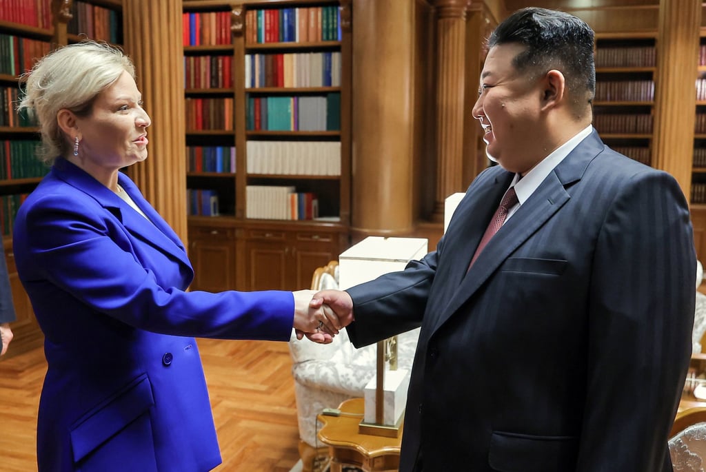 Russian Culture Minister Olga Lyubimova (left) shakes hands with Kim during their meeting at the headquarters of the Party Central Committee in Pyongyang on Sunday. Photo: KCNA/EPA-EFE