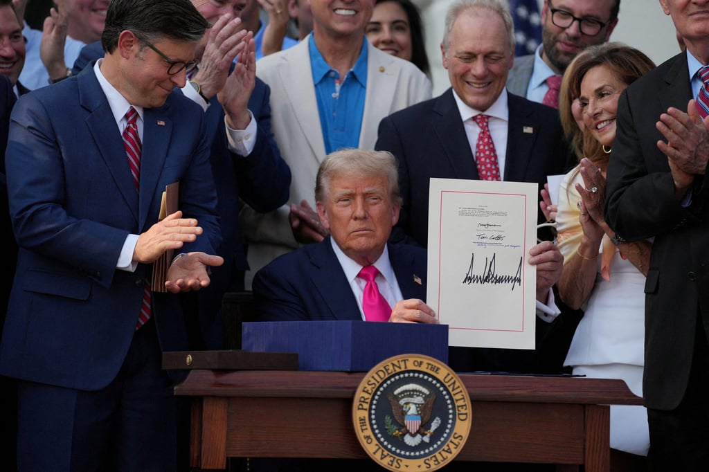 US President Donald Trump presents a sweeping spending and tax legislation after he signed it at the White House on Friday. Photo: Reuters US President Donald Trump presents a sweeping spending and tax legislation after he signed it at the White House on Friday. Photo: Reuters