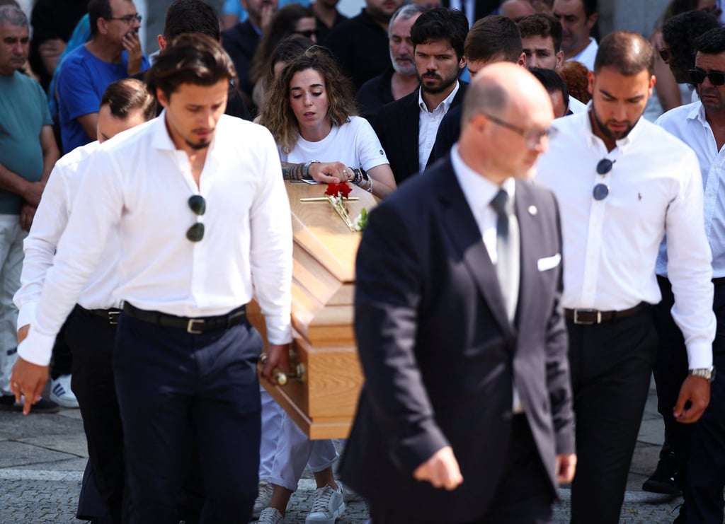 Rute Cardoso (middle) reacts as pallbearers carry her late husband’s coffin. Photo: Reuters Rute Cardoso (middle) reacts as pallbearers carry her late husband’s coffin. Photo: Reuters
