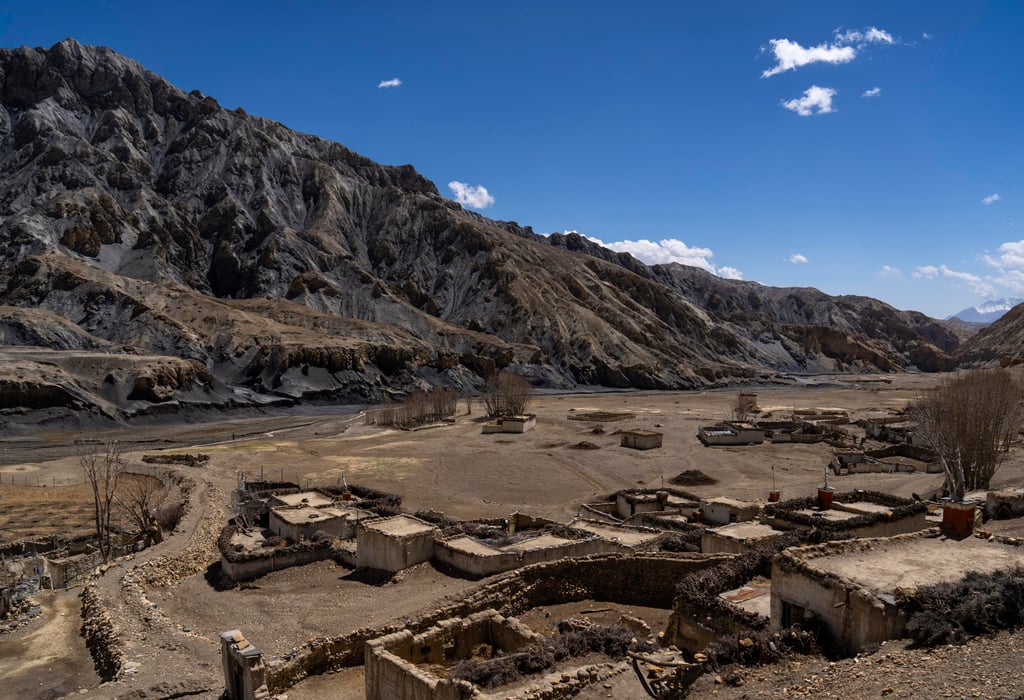 The abandoned village of Samjung, with ancient caves carved in the cliffs in the background. Photo: AP The abandoned village of Samjung, with ancient caves carved in the cliffs in the background. Photo: AP