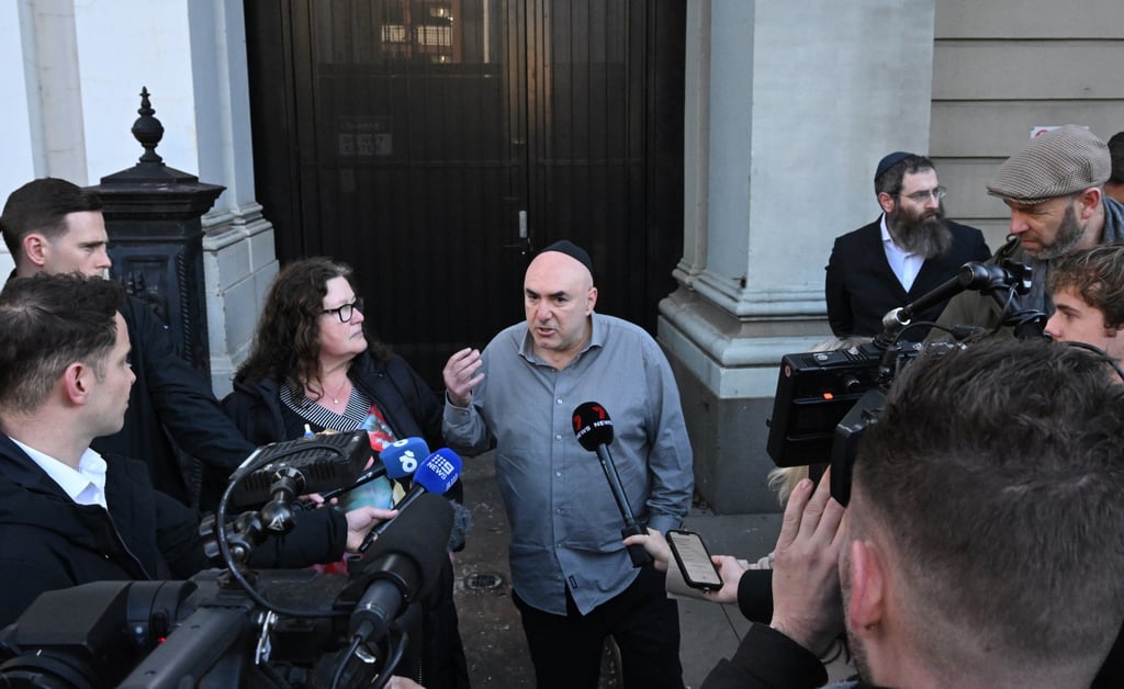 East Melbourne Hebrew Congregation President Danny Segal (centre) speaks to the media outside the East Melbourne Hebrew Congregation in Melbourne. Photo: AAP/dpa East Melbourne Hebrew Congregation President Danny Segal (centre) speaks to the media outside the East Melbourne Hebrew Congregation in Melbourne. Photo: AAP/dpa