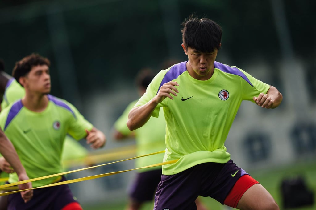 Tan Chun-lok (right) is put through his paces during training. Photo: HKFA