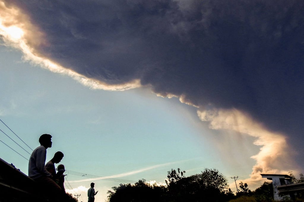 Villagers watch the ash cloud above Mount Lewotobi Laki-Laki as it erupts on Monday, as seen from Nangahale village in Sikka, East Nusa Tenggara province. Photo: AFP Villagers watch the ash cloud above Mount Lewotobi Laki-Laki as it erupts on Monday, as seen from Nangahale village in Sikka, East Nusa Tenggara province. Photo: AFP