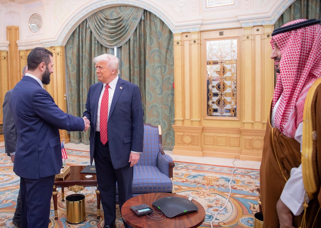 Syria’s interim President Ahmad al-Sharaa shakes hands with US President Donald Trump in Riyadh, Saudi Arabia, in May. Photo: Saudi Royal Palace via AP