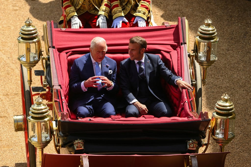 Britain’s King Charles and French President Emmanuel Macron travel in a horse-drawn carriage to Windsor Castle. Photo: Reuters