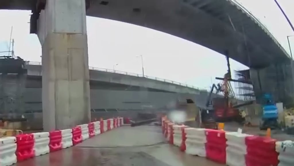 A dashcam video captures the collapsed iron beam landing on a road within the site. Photo: Handout A dashcam video captures the collapsed iron beam landing on a road within the site. Photo: Handout