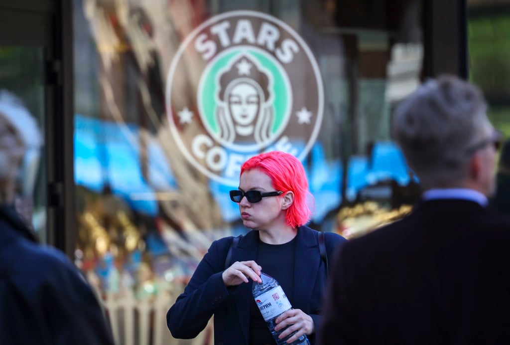 A woman walks past ‘Stars Coffee’, a Russian chain that opened in former Starbucks coffee shops. Photo: EPA
