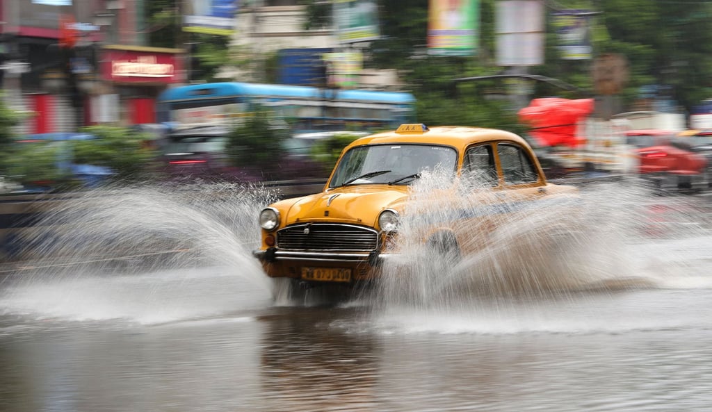 A taxi drives on a waterlogged street during heavy rain in Kolkata, India, on Tuesday. Photo: EPA A taxi drives on a waterlogged street during heavy rain in Kolkata, India, on Tuesday. Photo: EPA