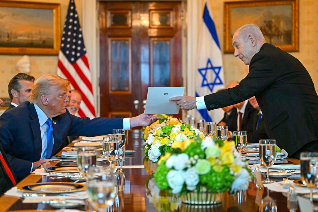 Israeli Prime Minister Benjamin Netanyahu (right) hands over a letter to US President Donald Trump at the White House on Monday. Photo: AFP Israeli Prime Minister Benjamin Netanyahu (right) hands over a letter to US President Donald Trump at the White House on Monday. Photo: AFP