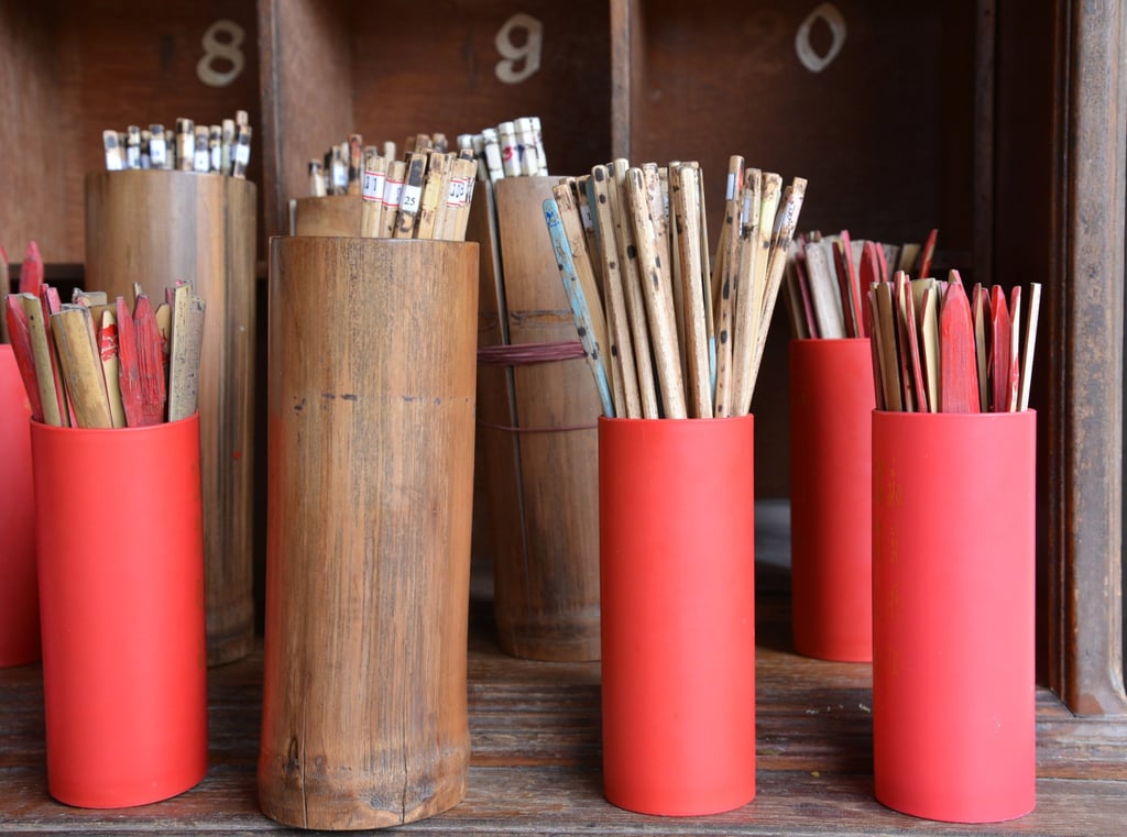 Numbered bamboo sticks in cylinders like these are used in qiuqian, a traditional method of fortune-telling that is popular in China. Photo: Shutterstock
