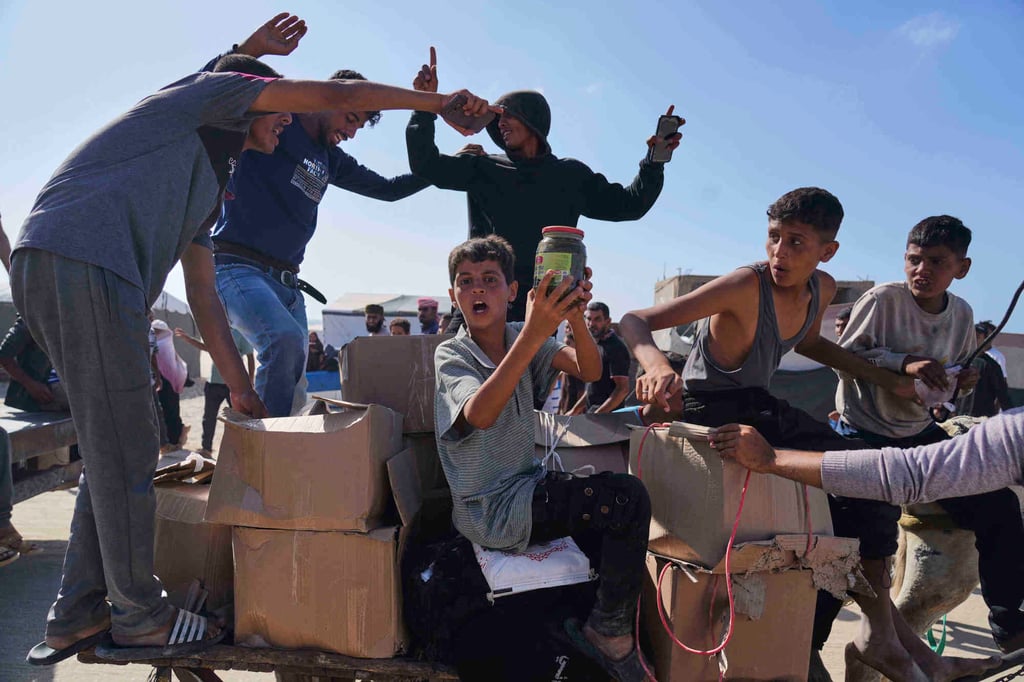 Palestinians carry boxes containing food and humanitarian aid packages delivered by the Gaza Humanitarian Foundation, a US-backed organisation approved by Israel, in Rafah, southern Gaza Strip, in May. Photo: AP Palestinians carry boxes containing food and humanitarian aid packages delivered by the Gaza Humanitarian Foundation, a US-backed organisation approved by Israel, in Rafah, southern Gaza Strip, in May. Photo: AP