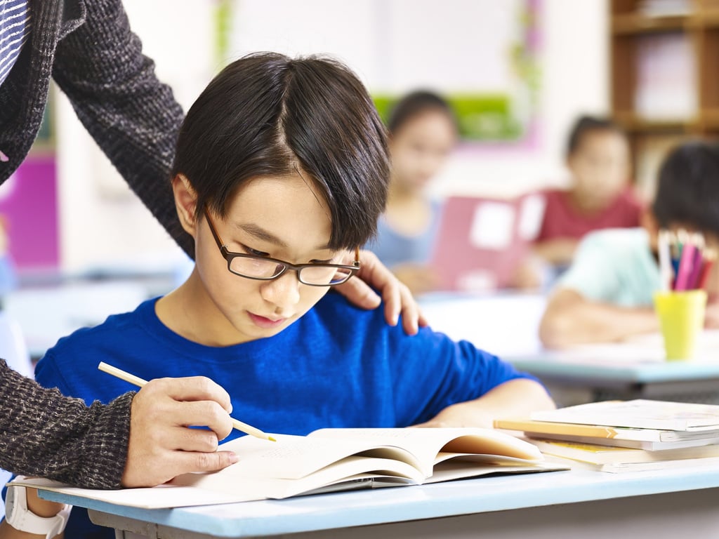 A pupil gets help from teacher in class. One of the most forceful condemnations of the proposed drama came from South Korea’s largest teaching union. Photo: Shutterstock A pupil gets help from teacher in class. One of the most forceful condemnations of the proposed drama came from South Korea’s largest teaching union. Photo: Shutterstock