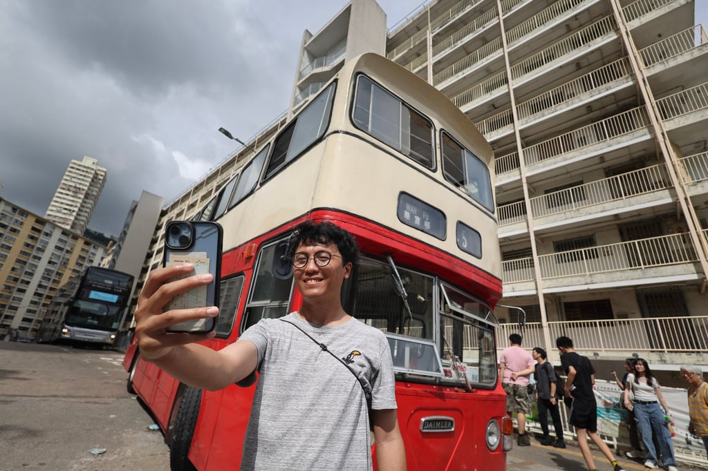 Artist Swing Lam takes a photo with the former route 45 bus at the estate. Photo: Dickson Lee Artist Swing Lam takes a photo with the former route 45 bus at the estate. Photo: Dickson Lee