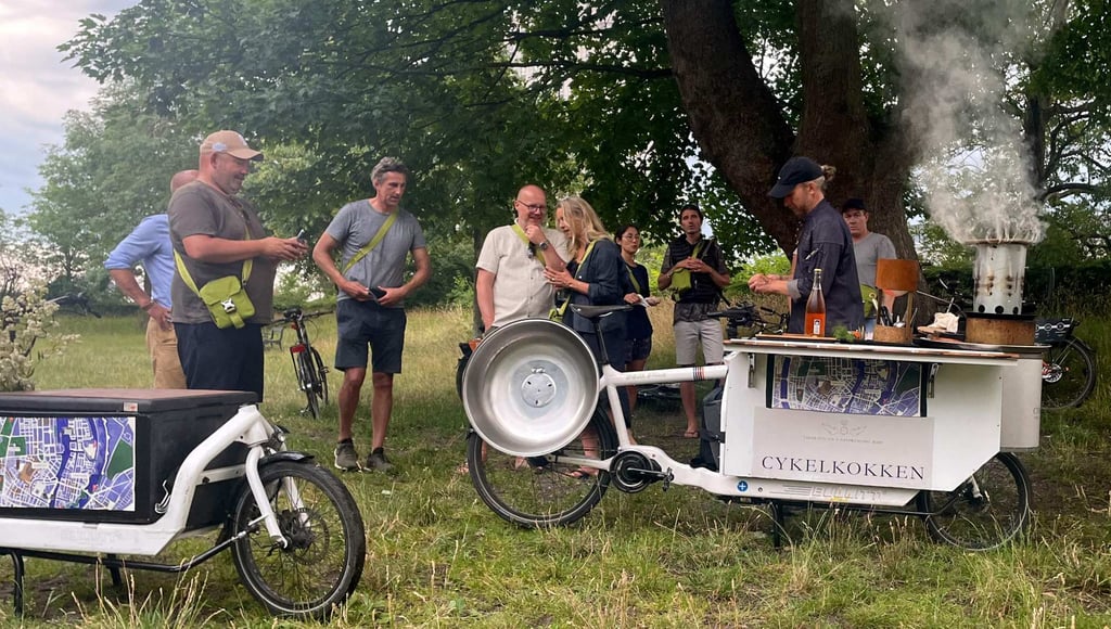 Danish chef Morten Kryger Wulff cooks on his self-designed kitchen-bike as he takes his customers on a gastronomical bike ride through Copenhagen. Photo: AFP