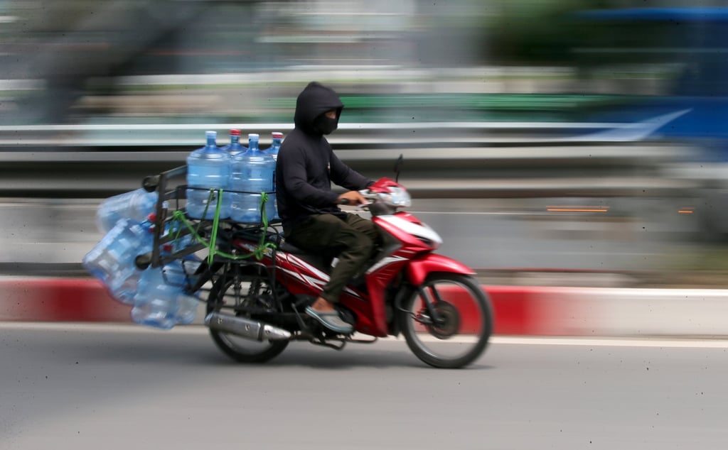 A man rides a motorbike on a street in Hanoi, Vietnam. Some Vietnamese are worried the ban will hit the working class the hardest. Photo: EPA