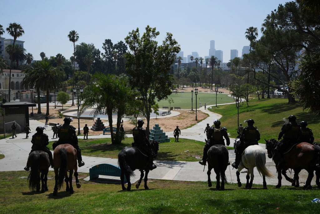Federal agents on horseback at MacArthur Park on July 7. Photo: AP