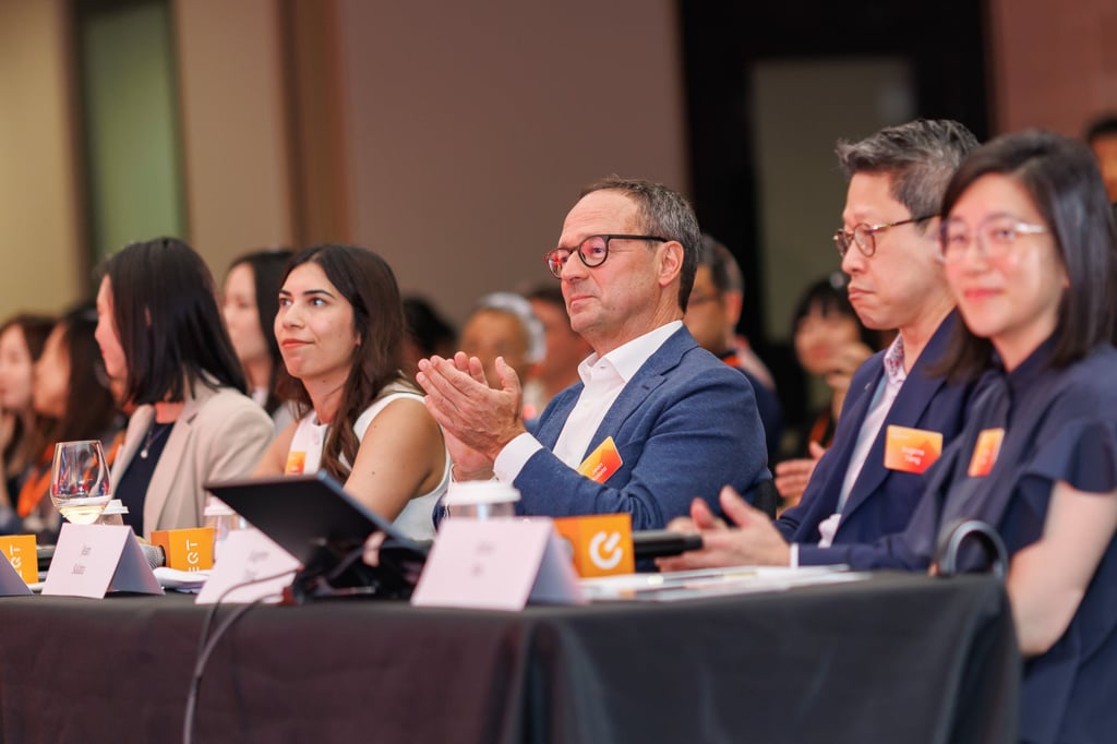 EQT Asia’s Jean Salata (applauding, centre) sits with fellow judges at the 2025 EQT Impact Challenge grand finale. Photo: SCMP