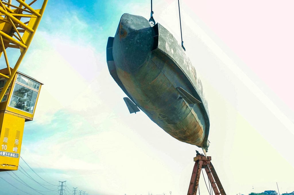 The homemade submarine made by Chinese farmer Zhang Shengwu is lowered into a river in Hanshan county on July 2. Photo: AFP